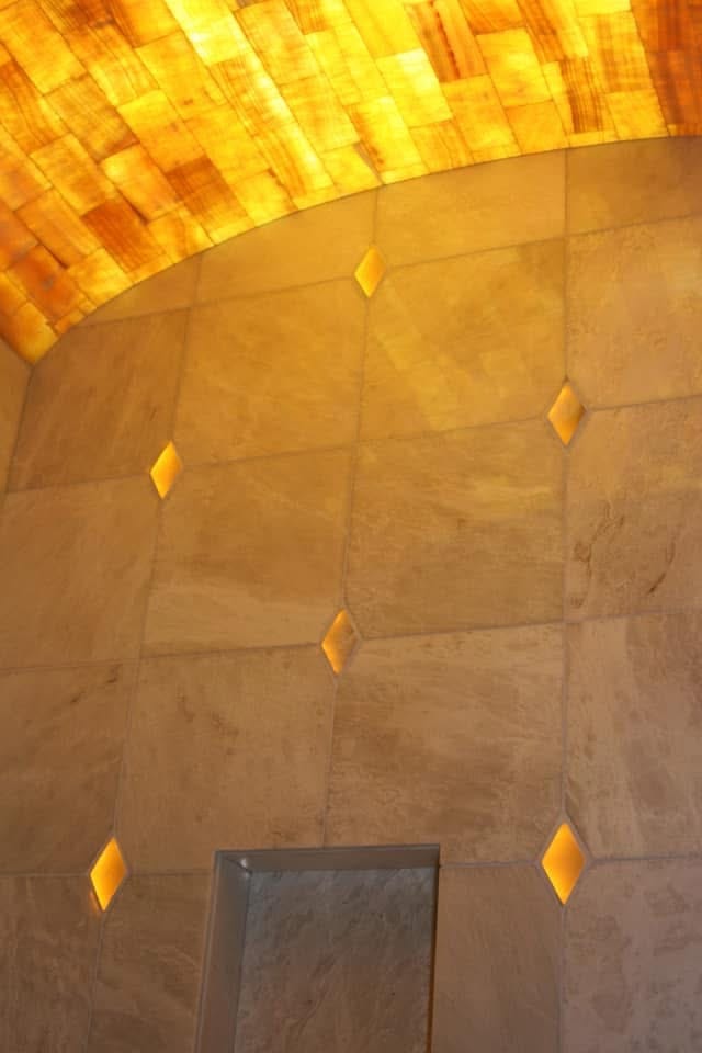 Award-winning lighted onyx masterbath ceiling with backlit onyx mosaic arch and glowing diamond accent pieces